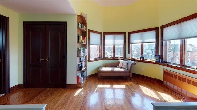 unfurnished room featuring light wood-type flooring and radiator