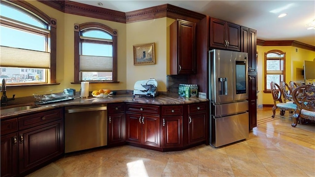 kitchen with crown molding, a healthy amount of sunlight, sink, and stainless steel appliances