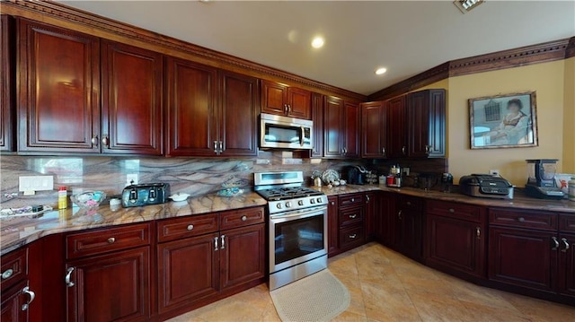 kitchen with light stone countertops, backsplash, stainless steel appliances, and light tile patterned flooring