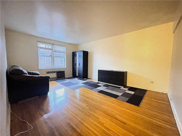 living room featuring radiator and dark hardwood / wood-style floors