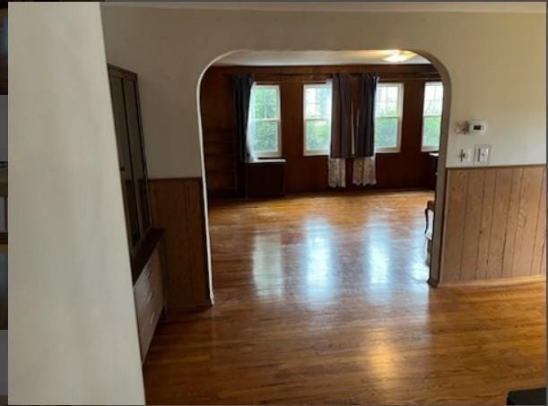 corridor featuring wood walls and light hardwood / wood-style floors