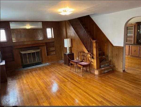 unfurnished room featuring wood walls and light hardwood / wood-style floors