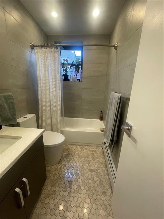 full bathroom with tile walls, vanity, a baseboard heating unit, toilet, and shower / bathtub combination with curtain