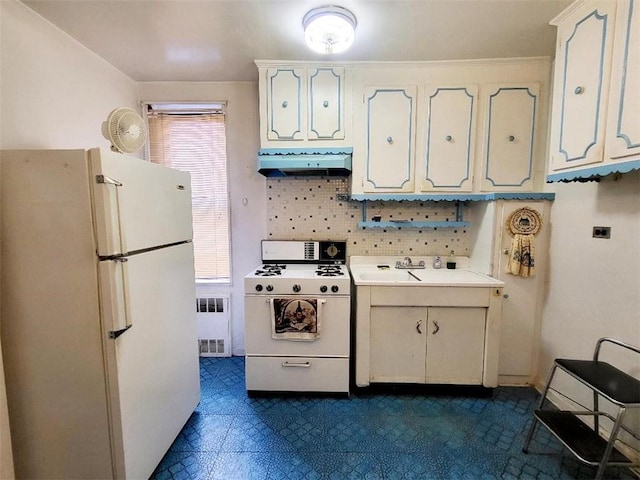 kitchen featuring white appliances, radiator heating unit, extractor fan, and plenty of natural light