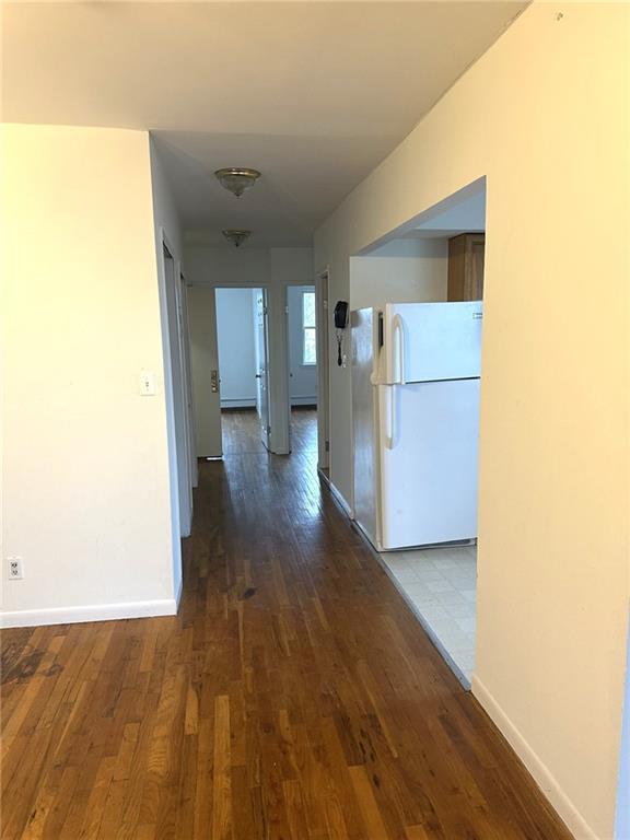 hall with dark hardwood / wood-style flooring