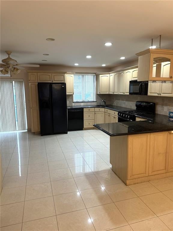 kitchen featuring light tile patterned floors, black appliances, kitchen peninsula, and ceiling fan