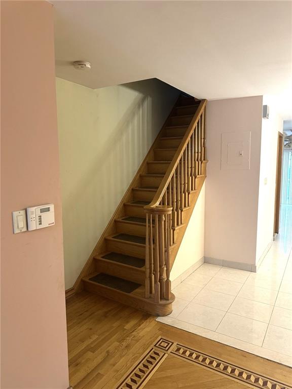 staircase with tile patterned floors