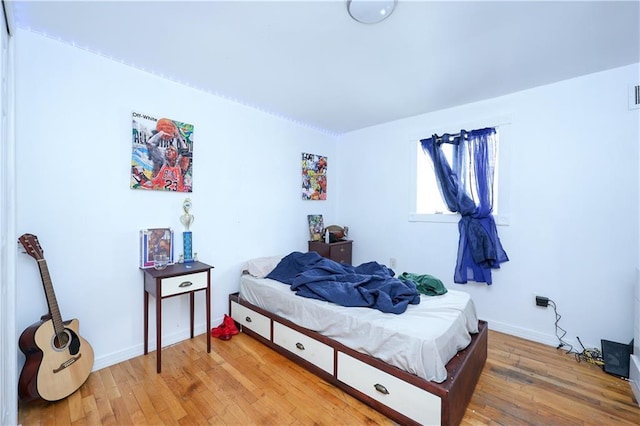 bedroom with wood-type flooring