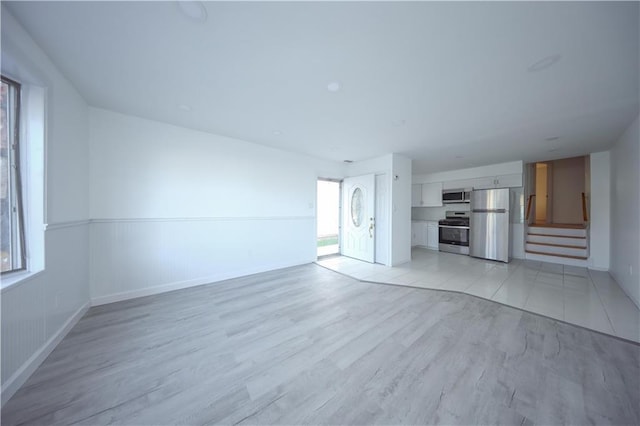 unfurnished living room with light hardwood / wood-style floors