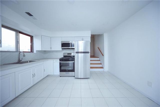 kitchen featuring white cabinets, sink, and appliances with stainless steel finishes