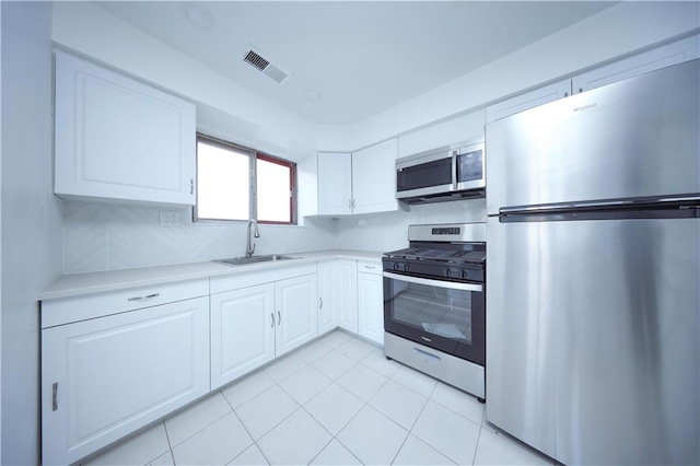 kitchen featuring white cabinets, stainless steel appliances, and sink