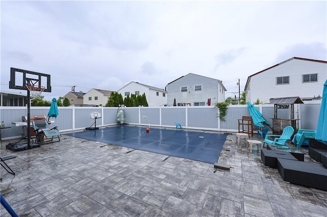 view of pool with a patio and an outdoor fire pit