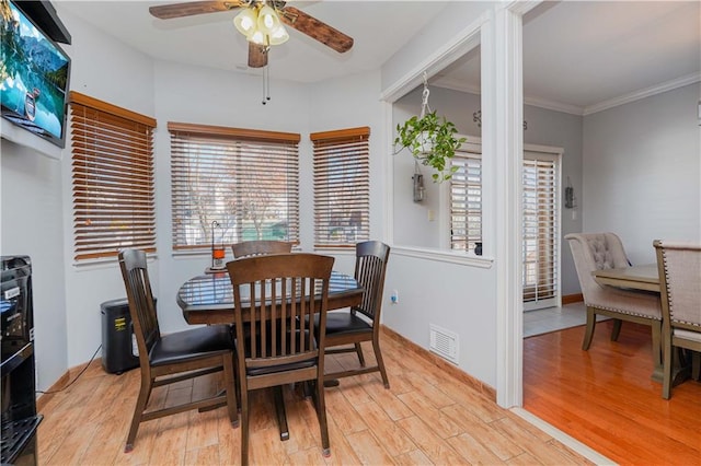 dining room featuring ceiling fan, ornamental molding, and light hardwood / wood-style flooring