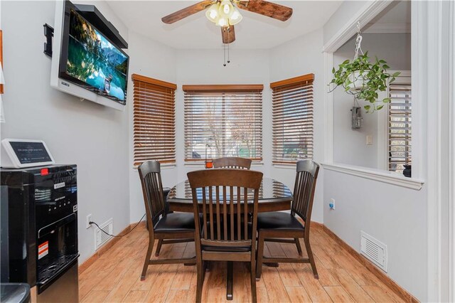 dining room with ceiling fan and light hardwood / wood-style floors