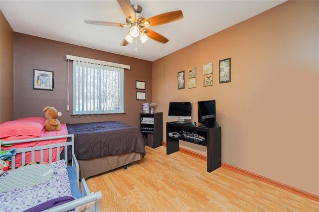 bedroom with ceiling fan and wood-type flooring