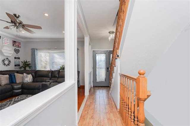 foyer with light hardwood / wood-style flooring, ceiling fan, and crown molding