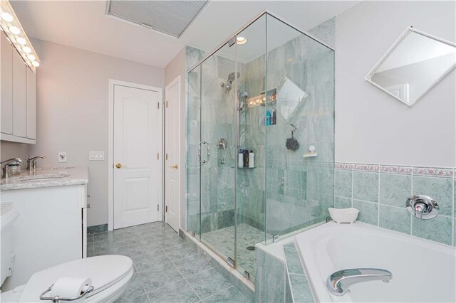 bathroom featuring tile patterned floors, vanity, and independent shower and bath