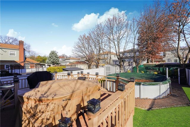 view of yard featuring a storage unit and a wooden deck