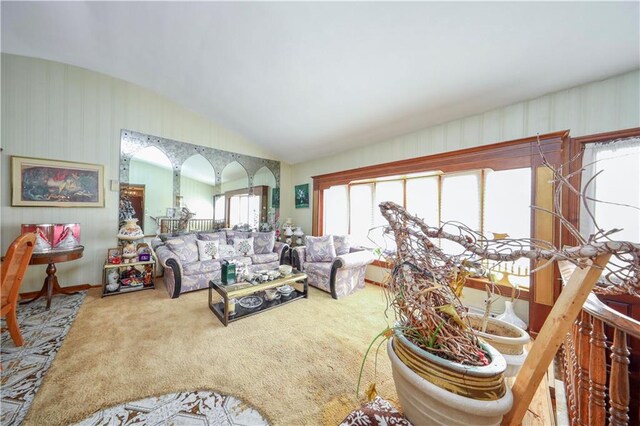 living room featuring carpet flooring and vaulted ceiling