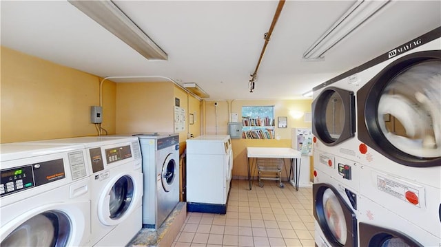 washroom featuring stacked washer and dryer and washing machine and clothes dryer