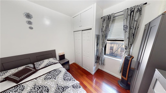 bedroom with a closet and dark hardwood / wood-style floors