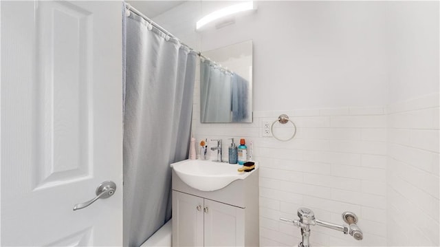 bathroom with vanity, tile walls, and shower / tub combo