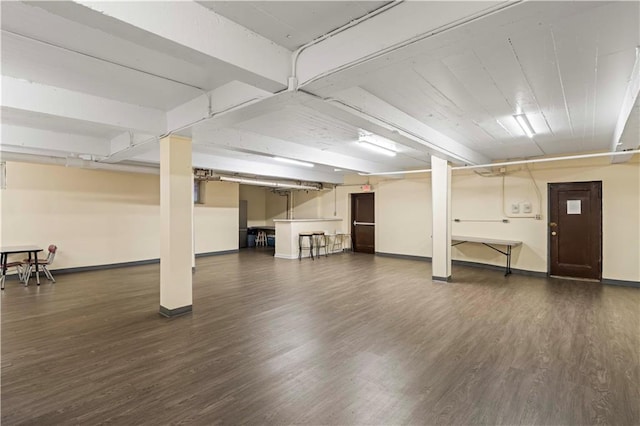 finished basement with baseboards and wood finished floors