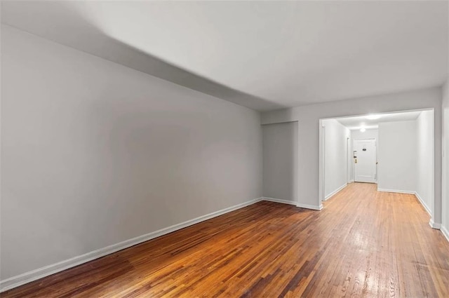 243 Mcdonald Ave Unit 1D, Brooklyn, NY 11218 - unfurnished living room with hardwood / wood-style flooring and baseboards