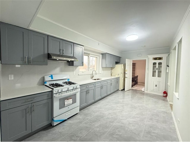 kitchen featuring gray cabinetry, crown molding, sink, and white appliances