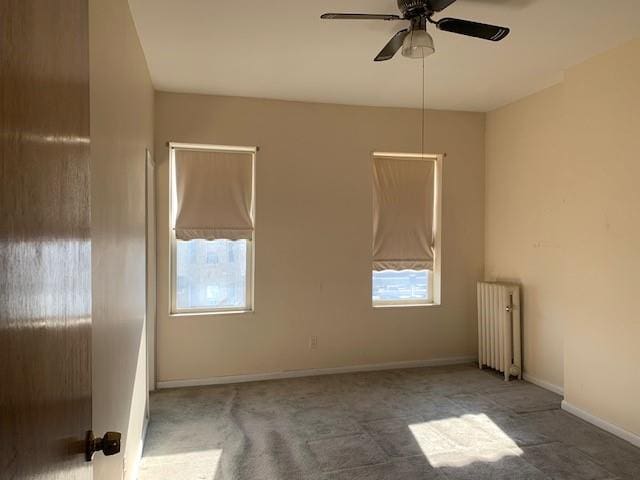 empty room with ceiling fan and radiator