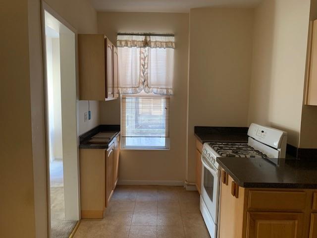 kitchen with gas range gas stove and a wealth of natural light