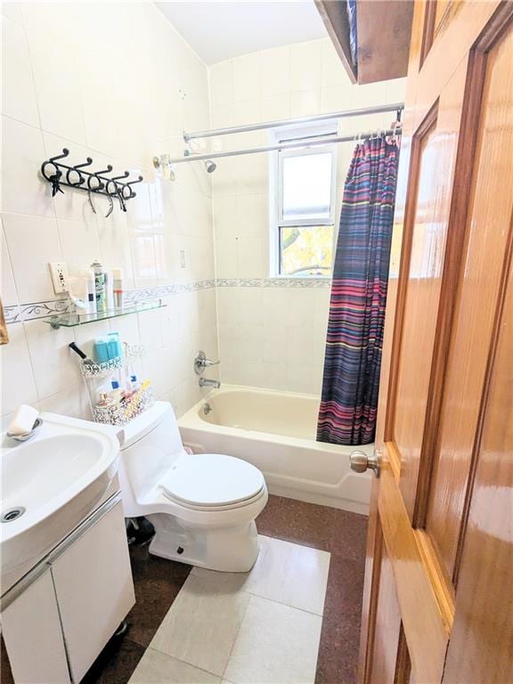 full bathroom featuring shower / tub combo, vanity, tile walls, tile patterned flooring, and toilet