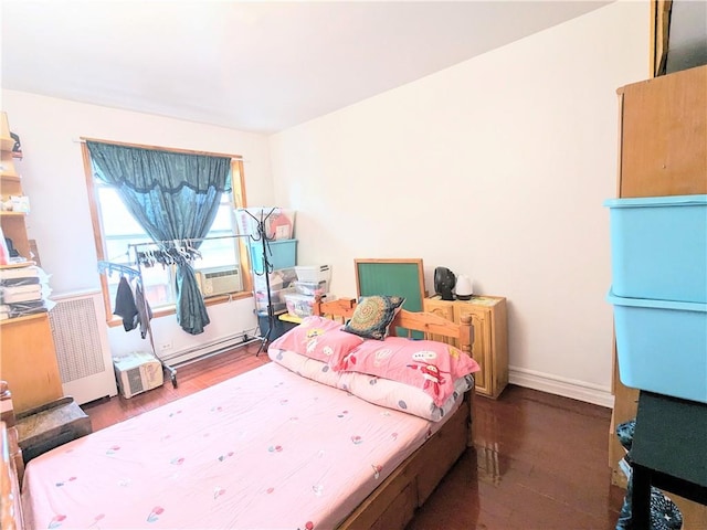 bedroom with dark hardwood / wood-style flooring