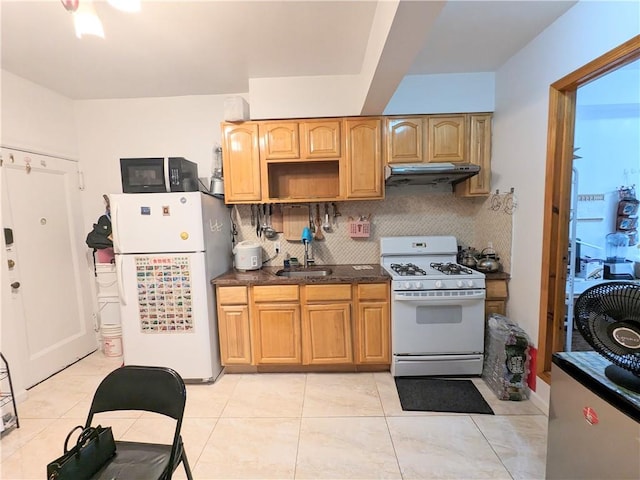 kitchen featuring decorative backsplash, sink, light tile patterned flooring, and white appliances