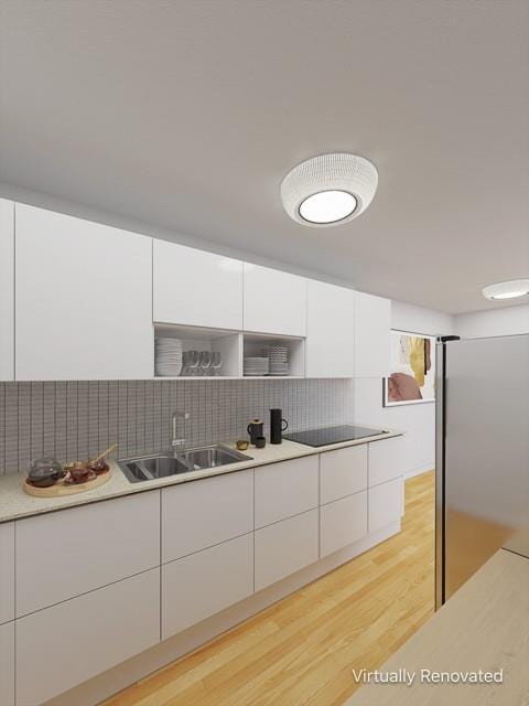 kitchen featuring tasteful backsplash, light wood-style flooring, modern cabinets, white cabinetry, and a sink