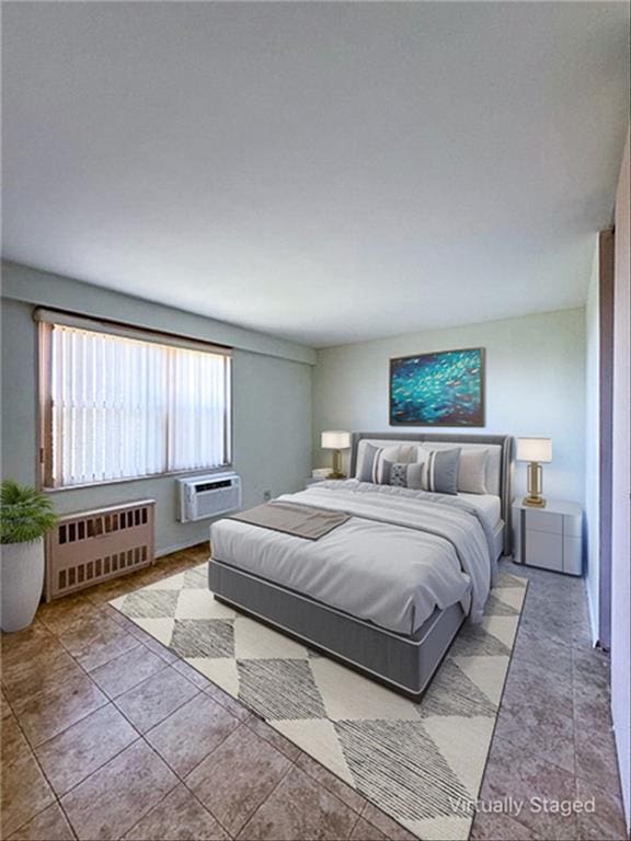 bedroom featuring a wall unit AC, light tile patterned flooring, and radiator