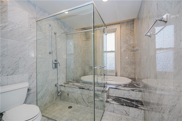 bathroom featuring toilet, a stall shower, and tiled bath