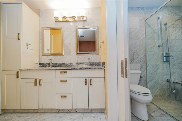 bathroom with marble finish floor, double vanity, a stall shower, and toilet