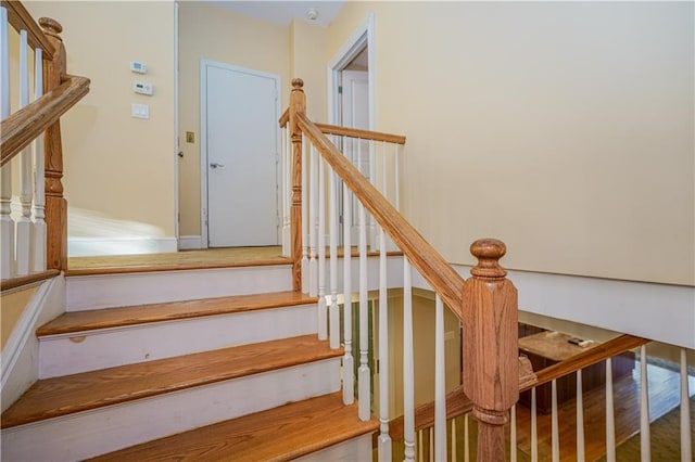 stairway with wood finished floors