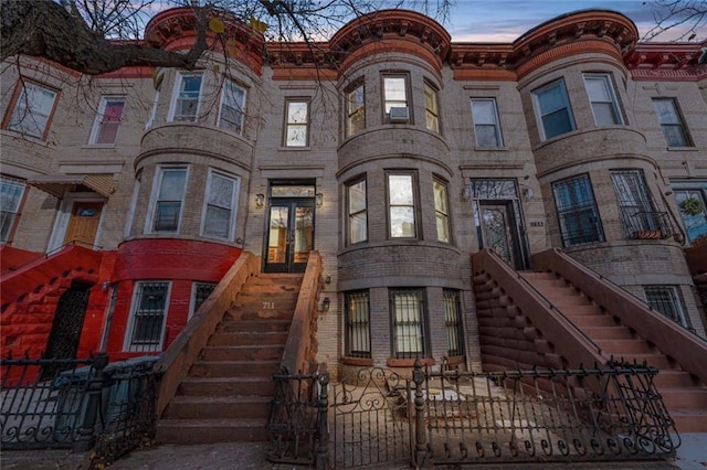 view of front of property with stairs and french doors