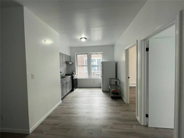 kitchen featuring dark hardwood / wood-style flooring, white refrigerator, gray cabinetry, and stainless steel electric range