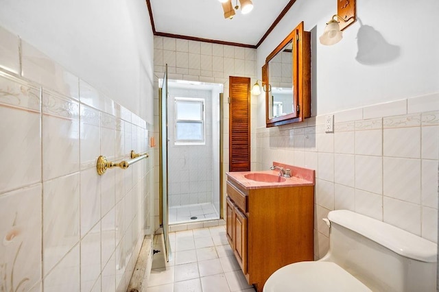 full bathroom with tile patterned floors, toilet, tile walls, a shower stall, and crown molding