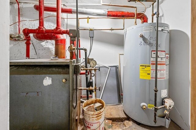 utility room featuring gas water heater