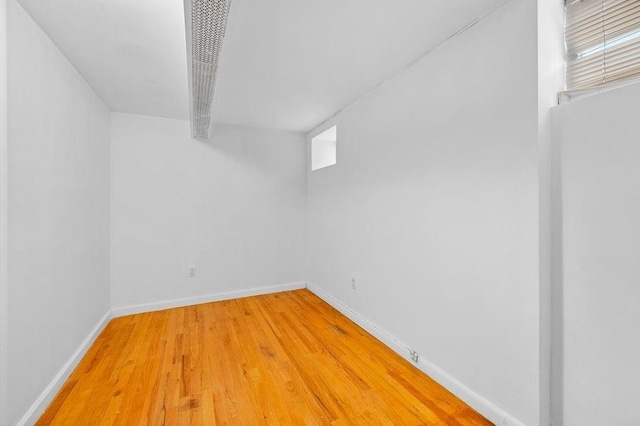 spare room featuring light wood-style flooring and baseboards