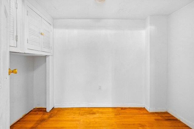 unfurnished room with hardwood / wood-style floors