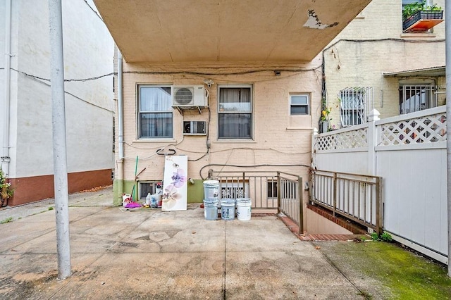 view of patio with ac unit and fence