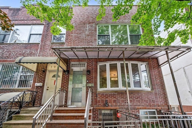 townhome / multi-family property featuring brick siding