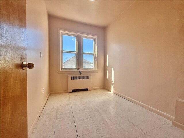 bonus room featuring radiator heating unit