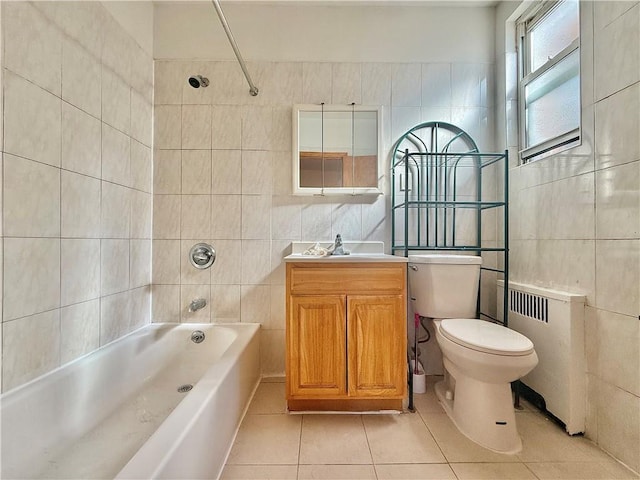 full bathroom with tiled shower / bath, radiator, tile walls, tile patterned flooring, and toilet