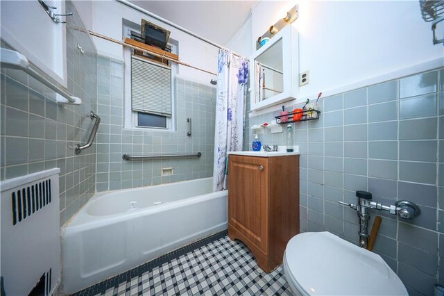 bathroom featuring shower / tub combo, tile patterned floors, tile walls, radiator heating unit, and toilet